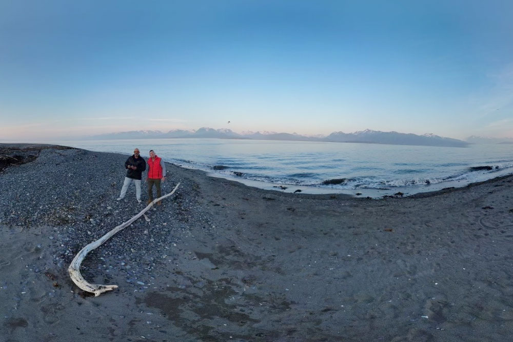 Two people standing on the shore line